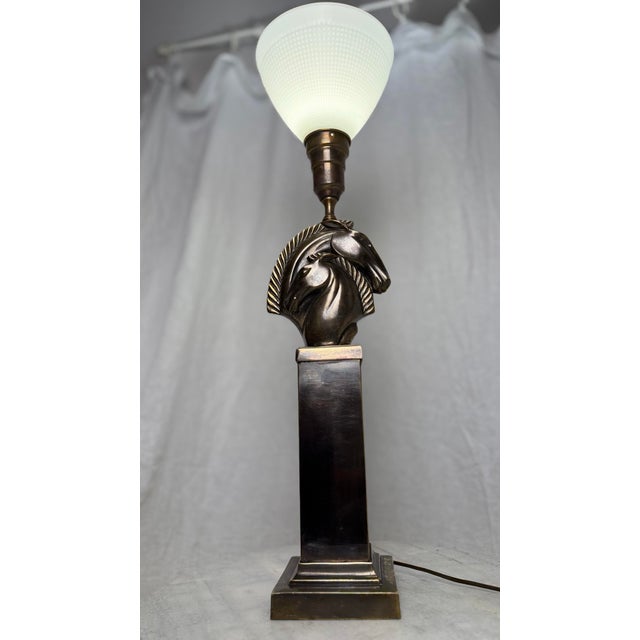 Bring a striking sculptural presence to your space with this exceptional Mid-Century Modern French-style double horse head...