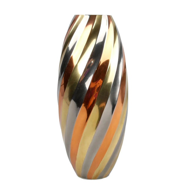 Unique Ribbed vase featuring swirls of brass, copper, and chrome. Perfect for the modern or contemporary home!