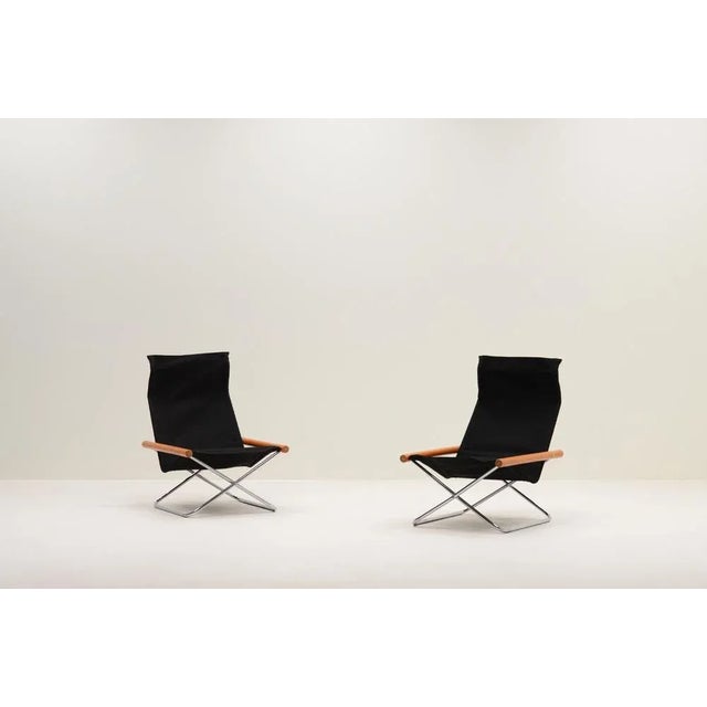 Set of 2 ny chairs by takeshi nii, 1950s japan. Minimalistic folding chairs with a chrome x-base, beech wood arm rests and...