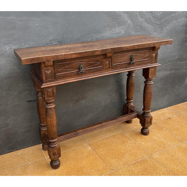 Elegant Spanish console table in the Renaissance Revival style, dating from the early 20th century. The piece features a...