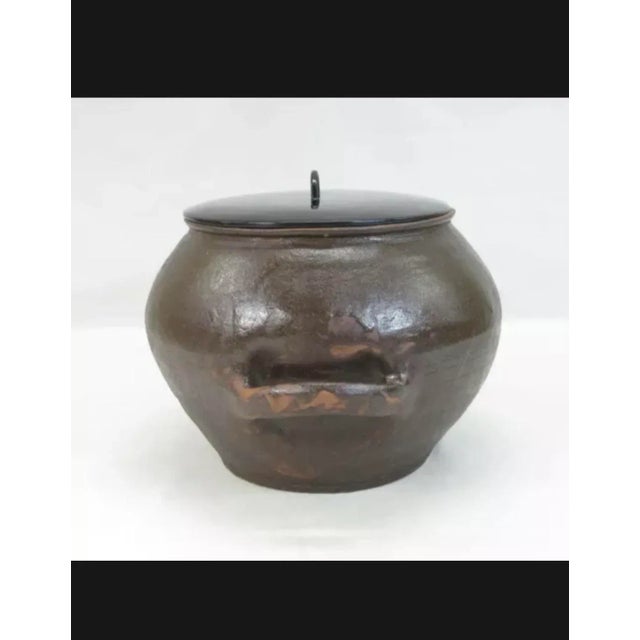 A glazed mizusashi or water vessel used for tea ceremonies in Japan. Likely created in SE Asia, this item was exported to...