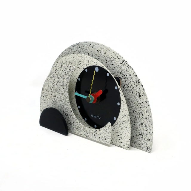 With a stunning combination of spotted gray and black enameled metal, black lucite accents, and primary colored hands,...