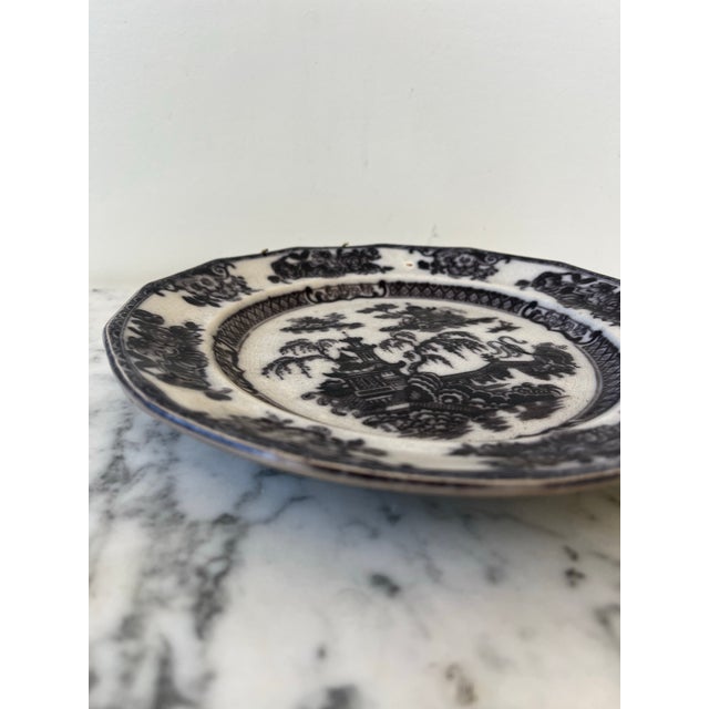 Porcelain black toile decorative plate with wall hanger. Stamped.