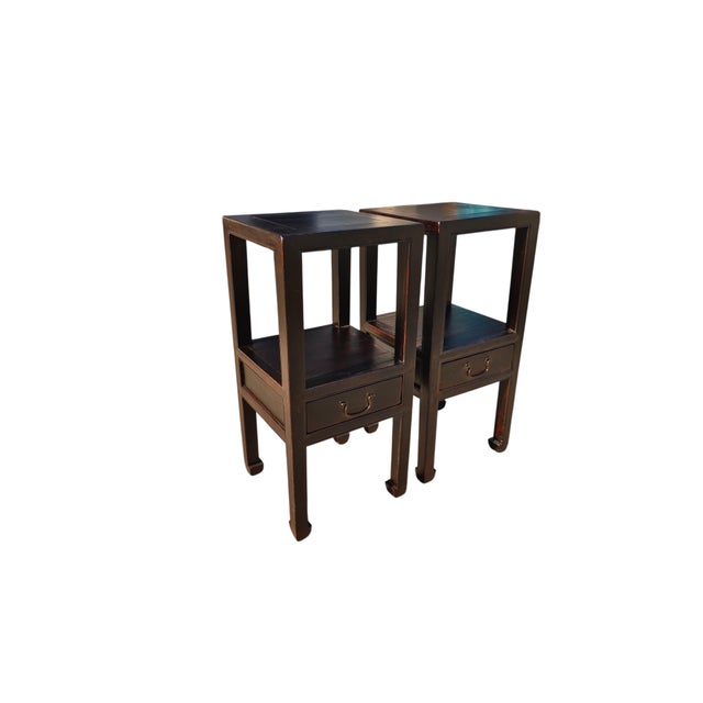 This antique pair of elegant Asian accent tables is made of solid elm. Finished in a rich, dark lacquer, each table...