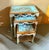 Elegant set of three French-style nesting tables featuring a beautiful soft sky blue finish accented with luxurious gold...