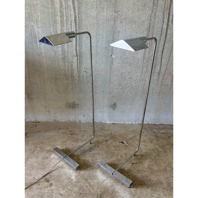 A pair of mid century modern chrome floor lamps by Cedric Hartman, model 1UWV. Clean, functional design with adjustable...