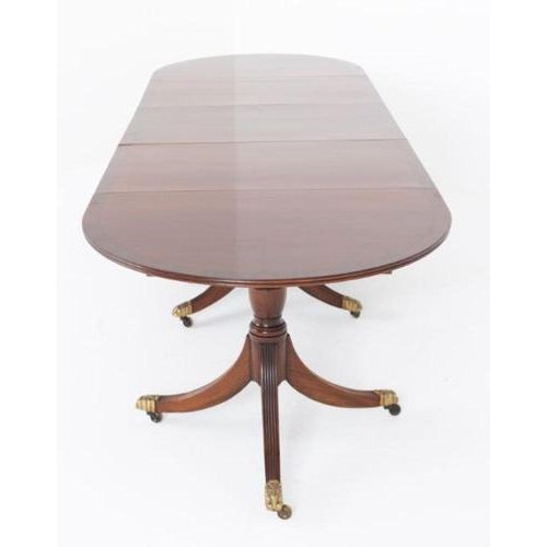 A fine Regency Revival three-pedestal dining table of impressive scale and elegant design The table stands upon three...