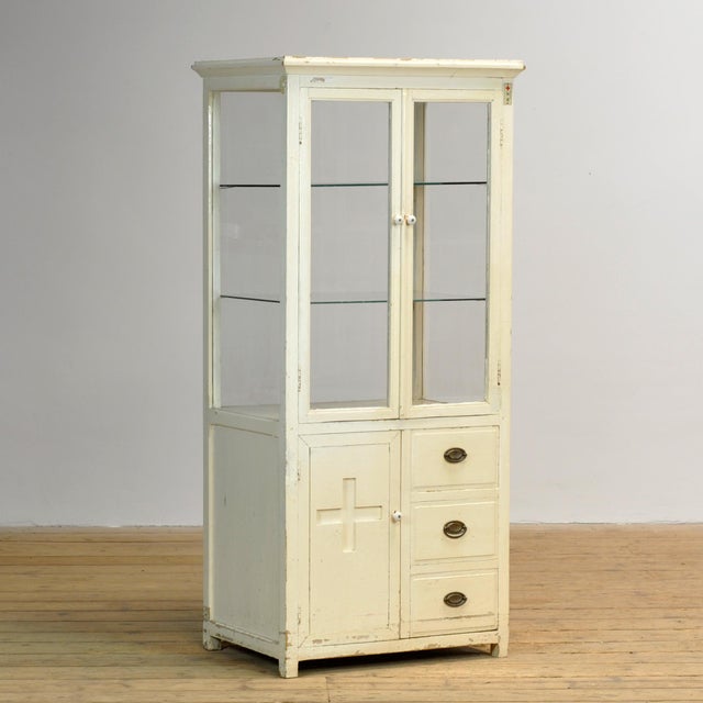 A distinctive antique Japanese cabinet, originating from a medical or nursing context associated with the Japanese Red...