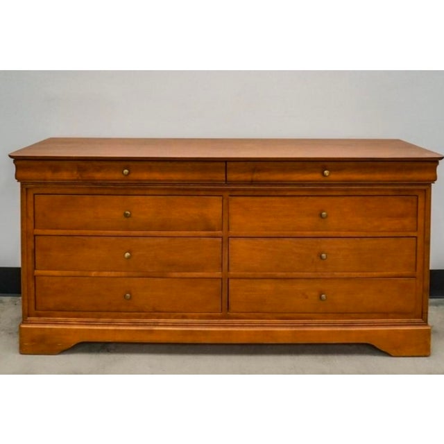 Enhance your bedroom with this timeless, elegant Louis Philippe style double dresser and matching landscape mirror set....