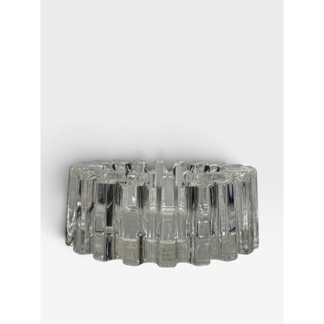This is a vintage Mid-Century Modern clear glass bowl featuring a bold sculptural form with thick, repeating rectangular...