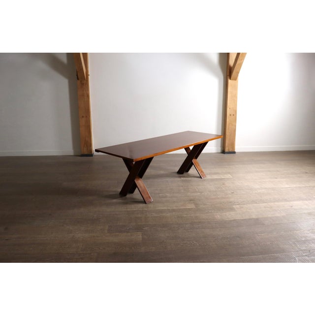 A refined walnut dining table model tl58 by italian designer marco zanuso, produced during the 1960s. the table is...