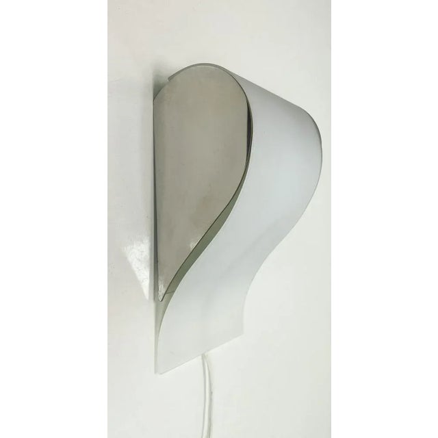 Modern style Leucos Wall Lamp. Made of chromed metal with satin finish glass. The design is playfully modern and unusual...
