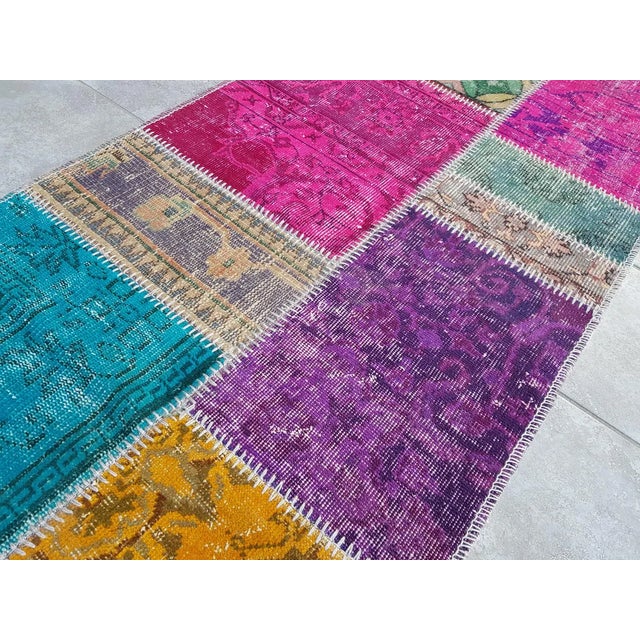 This is a vintage Turkish Oushak rug from the Mid 20th Century. The piece was hand-knotted.