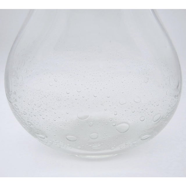 Mid-century blown transparent glass vase filled with effervescent bubbles that rise up from the base. The vase has an oval...