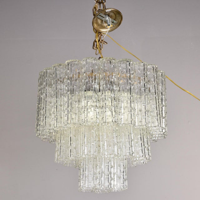 Found in Italy, this six light, three tiered glass fixture dates from the 1960s. Metal frame supports three tiers of tube-...