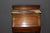 Small mahogany slant-front desk, opening with one drawer, two interior drawers, and a drop-front. Width with drop-front...