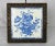 An antique circa 1880’s French tile music box trivet. White tile with a blue floral basket design. Hardwood frame...
