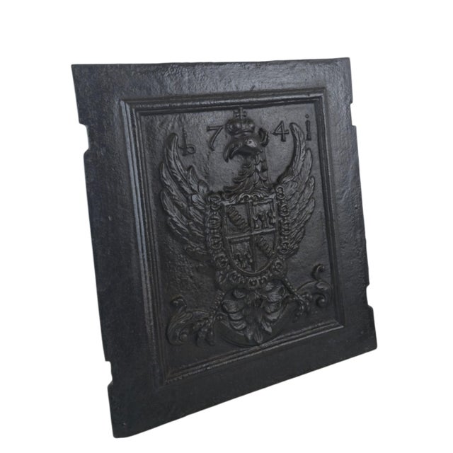 A Baroque stove plate (Ofenplatte), dated 1741. Cast iron, in relief. A crowned eagle is shown displayed, a quartered...