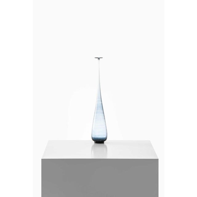This very rare and large glass vase, designed by Nils Landberg and produced by Orrefors in Sweden in 1964, is a refined...