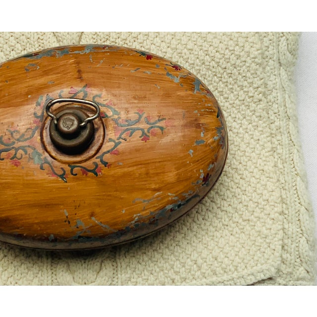 A charming vintage Hailo bed warmer, oval in form and sweetly plump, given a later hand-painted faux bois wood-grain...