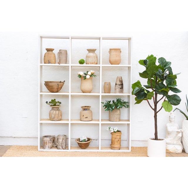 This magnificent bookcase is a study in rustic elegance and timeless design. This vintage 20th-century Acacia bookcase...