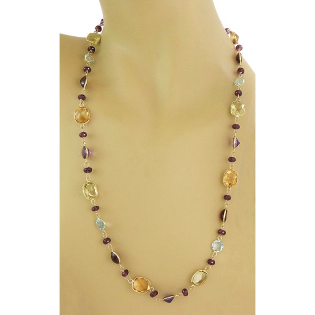This multicolor 10k yellow gold necklace features assorted shape gemstones in a beaded style. The vintage piece comes from...