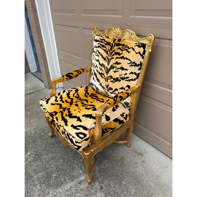 A striking French Regency style armchair, distinguished by its hand-carved giltwood frame and newly upholstered in the...