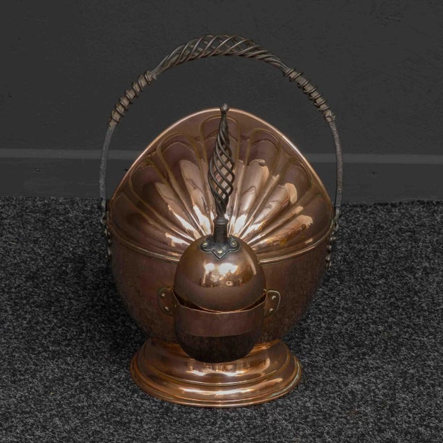 A beautiful copper helmet-shaped coal bucket from the Victorian period. The hood has an attractive embossed pattern,...