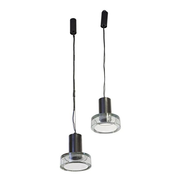 A pair of 1950s suspension lights, blown glass shades circular shaped on a solid black enamel structure. A design made in...