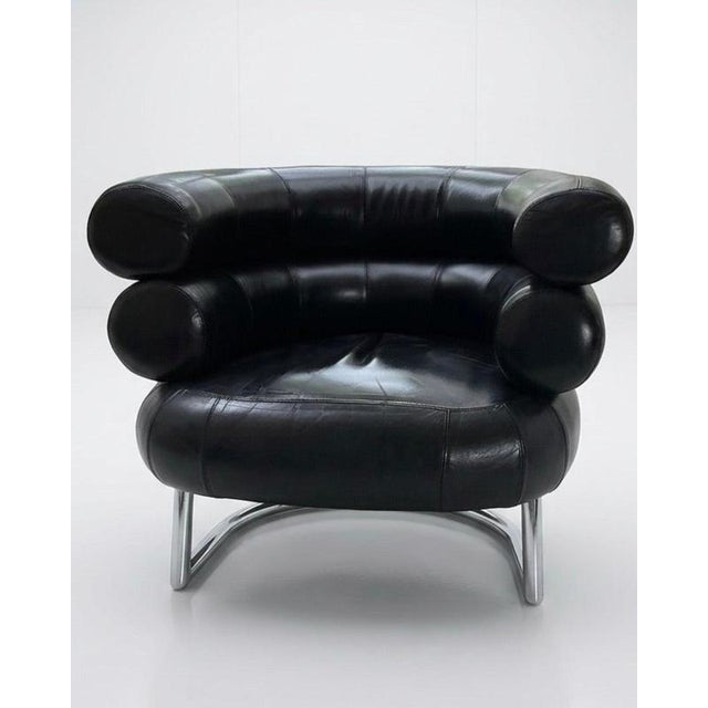 Elegant black faux leather armchair in the style of the iconic design by Eileen Gray. This piece combines modernist design...