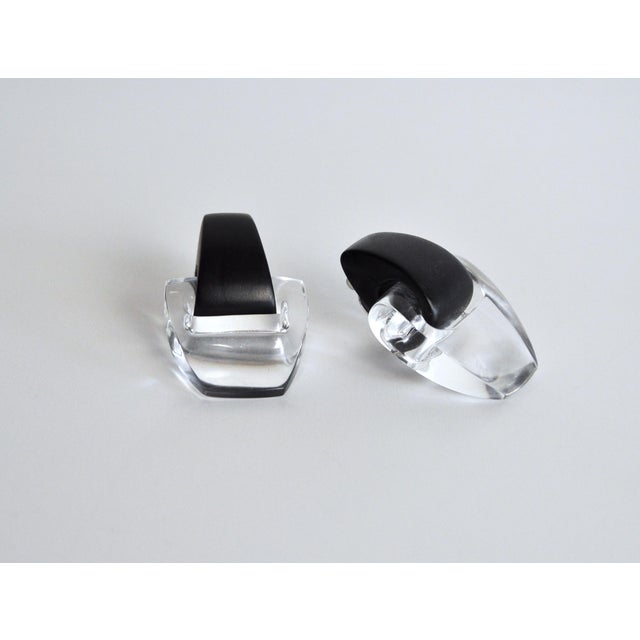 Pair of acrylic earrings in black and transparent. Clip-on fastening. Silver-tone hardware. Dimensions: Height 5.5, width...