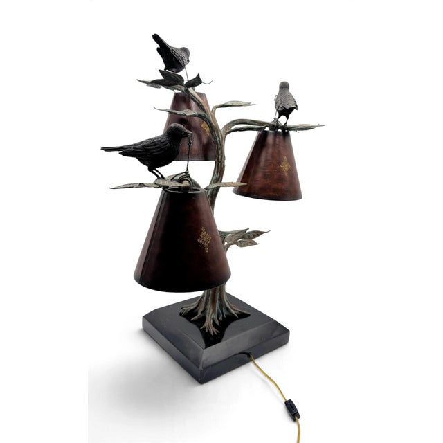 Maitland Smith 3-Light table lamp with finely cast, patinaed bronze depicting birds in a tree on a marble base. Shades are...