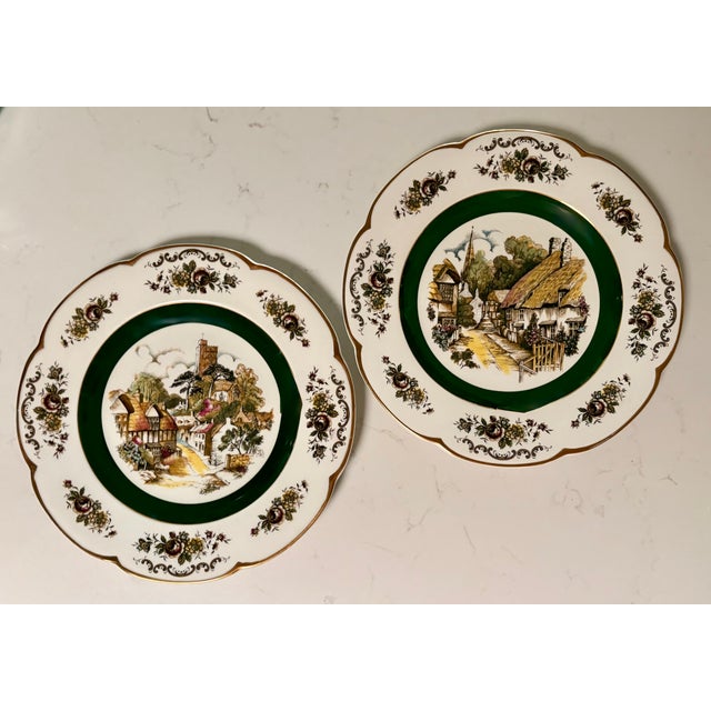 This set of two lovely scalloped edge plates, trimmed in gold, feature a wide border of flowers, a forest green inner...