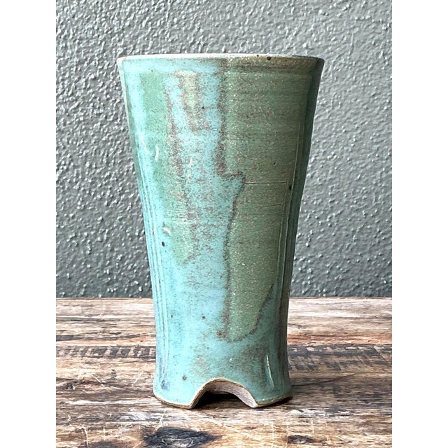 This vintage studio pottery vase is a beautifully restrained example of mid-century ceramic artistry, celebrating organic...