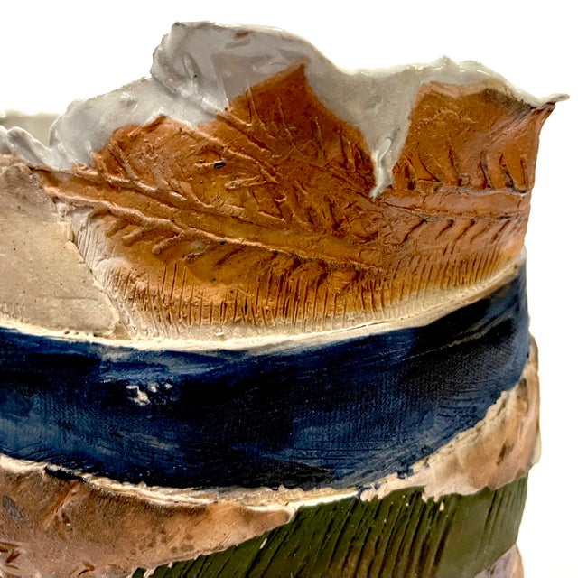 Naturally tactile and visually stunning - this oval art pottery slab vase is sure to wow. Striped/banded exterior features...