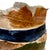 Naturally tactile and visually stunning - this oval art pottery slab vase is sure to wow. Striped/banded exterior features...