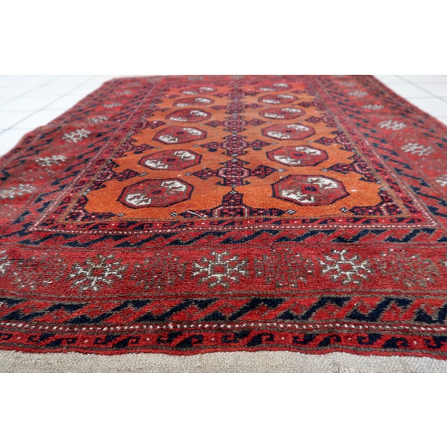 Immerse yourself in history with the Handmade Antique Afghan Baluch Rug from the 1920s. Design and Aesthetics: Dating back...
