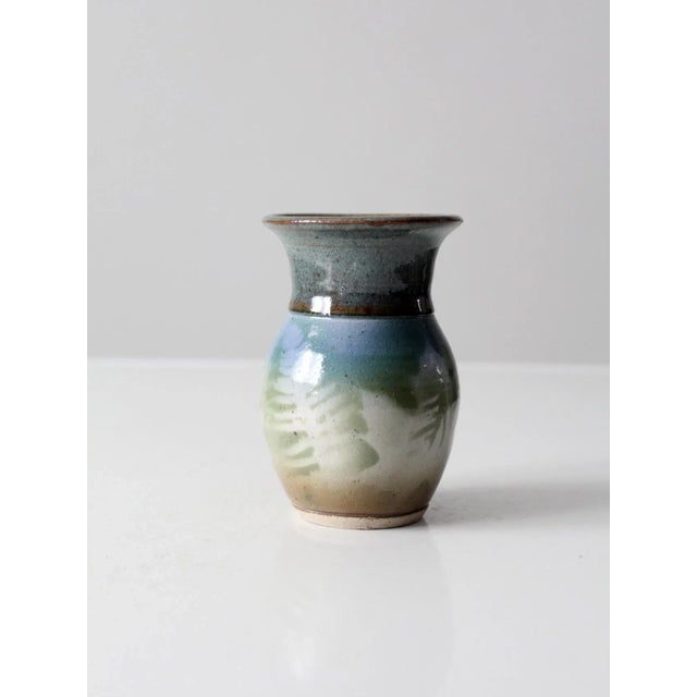 This is a vintage studio pottery vase. Signed by the artist, the hand-crafted vase features a beautiful blue and green...