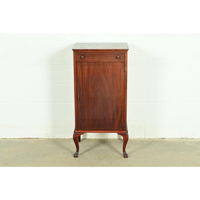 A gorgeous antique Victorian or Queen Anne music cabinet or record cabinet USA, Circa 1900 Carved mahogany, with satinwood...