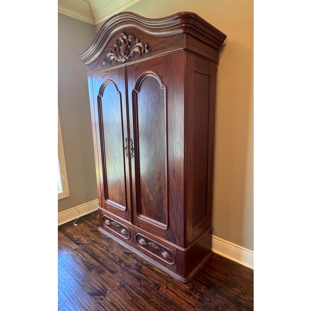 Elevate your space with this magnificent mid-19th-century American Rococo Revival wardrobe armoire, dating from the...