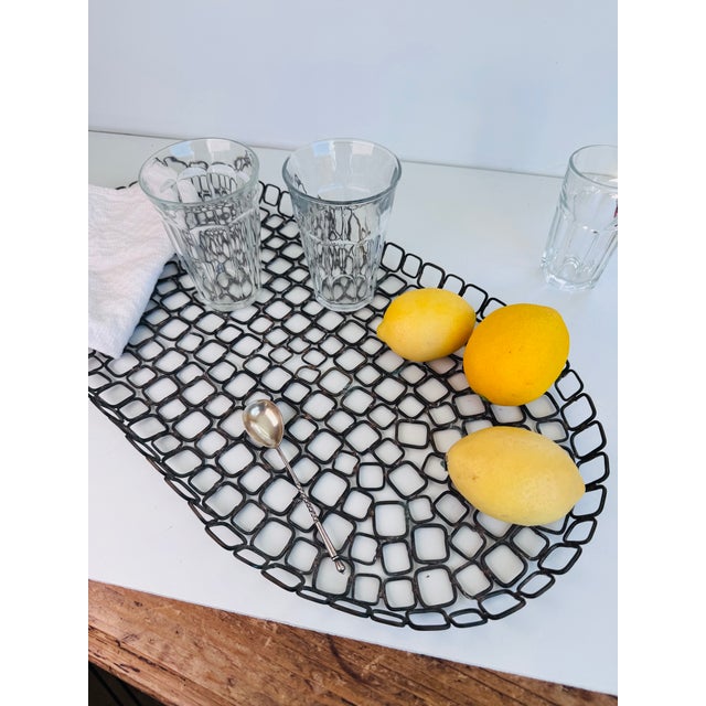 A modern, refined yet rustic tray in the Brutalist style. A nice piece that will work well with layering your decor....