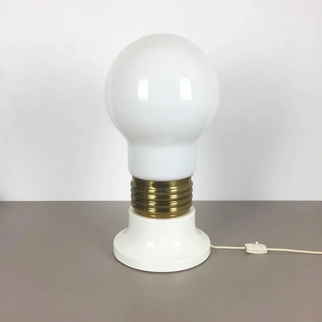Giant bulb light, origin Italy, 1970s. Original 1970s giant glass bulb table light. The base and middle of this light are...