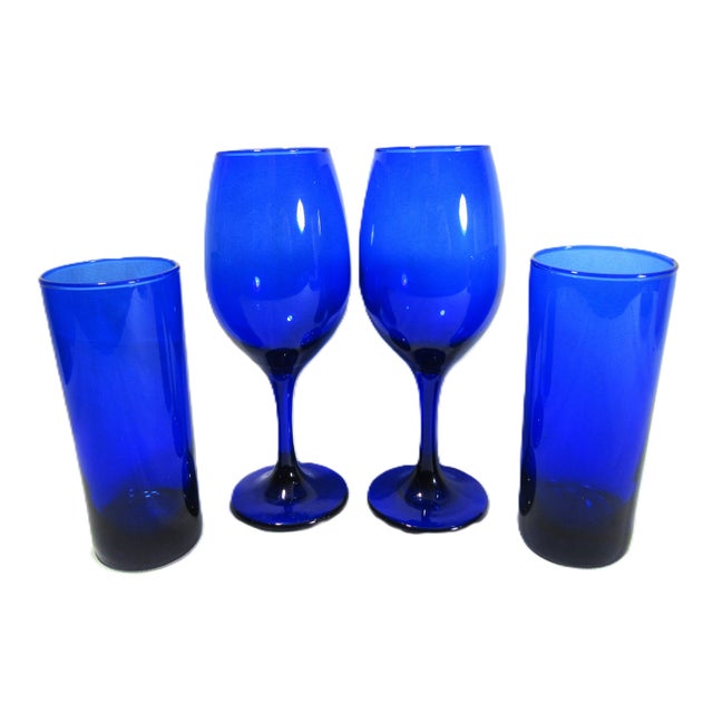 I have always been a lover of blue glass. These are 2 stemmed wine glasses and 2 6" tall high ball glasses. Probably...