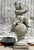 This charming vintage Regency cast concrete figural sculpture features a whimsical depiction of a cherub seated atop a...