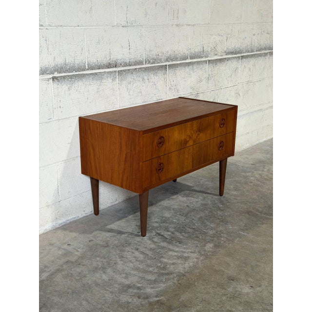 Beautiful vintage Danish Modern small dresser crafted in teak, featuring clean Scandinavian lines, sculptural recessed...