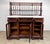 A magnificent, large Victorian-style mahogany sideboard or buffet featuring a marble top, glass-front cabinet doors, and...