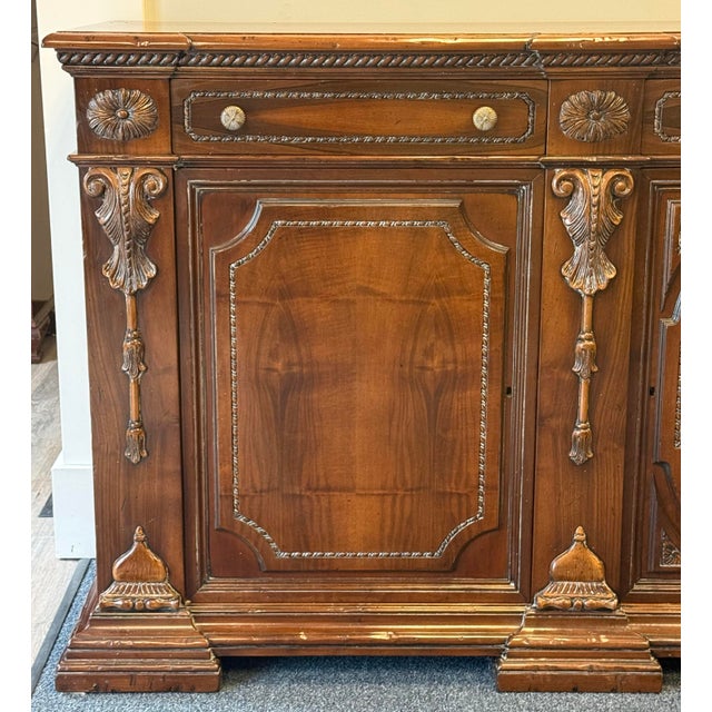 Impressive grand-scale sideboard featuring a richly warm wood finish and beautifully carved European-inspired detailing....