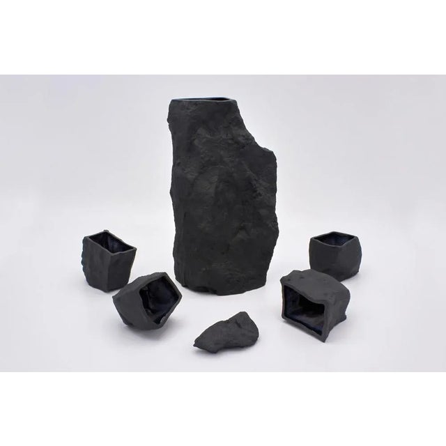 Black Carafe and cups set by Craig Barrow. Dimensions: 7.5 x 10.5 x 20.5cm - 6 x 5 x 5.5cm Volume approx.: 400ml - 50ml...