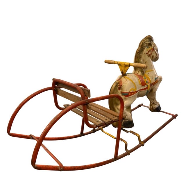 Material: Pressed steel/tinplate body with a wooden seat carriage. Design: Features original painted detailing, including...