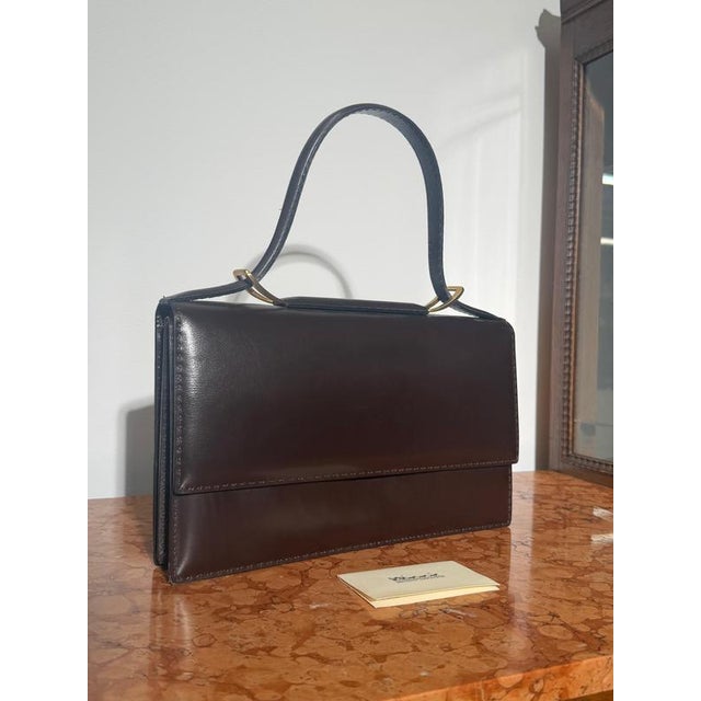A beautifully crafted vintage Delvaux top handle handbag, showcasing the timeless elegance and exceptional craftsmanship...